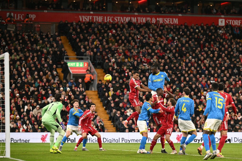 Wolverhampton Wanderers' Nigerian striker #14 Tolu Arokodare (C) wins a header in the build-up to their first goal during the English Premier League football match between Liverpool and Wolverhampton Wanderers at Anfield in Liverpool, north west England on December 27, 2025.