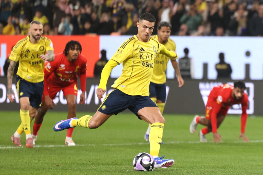 Al-Nassr's Portuguese forward #07 Cristiano Ronaldo shoots from the penalty spot to score his team's first goal during the Saudi Pro League football match between Al-Nassr FC and Al-Qadsiah at al-Awwal Park stadium.