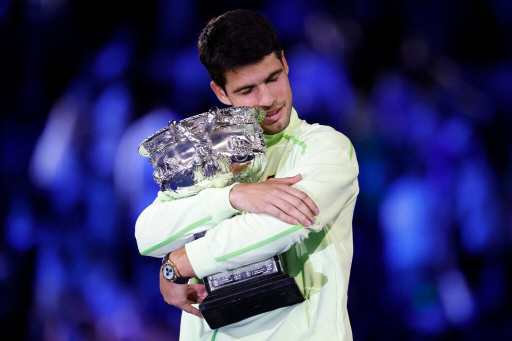 Carlos Alcaraz of Spain hugs the Norman Brookes Challenge Cup at the presentation ceremony after his victory in the Men's Singles Final against Novak Djokovic of Serbia during day 15 of the 2026 Australian Open at Melbourne Park on February 01, 2026 in Melbourne, Australia.