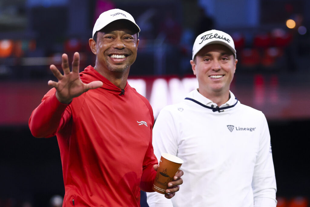 Tiger Woods talks with Justin Thomas before a match at SoFi Center