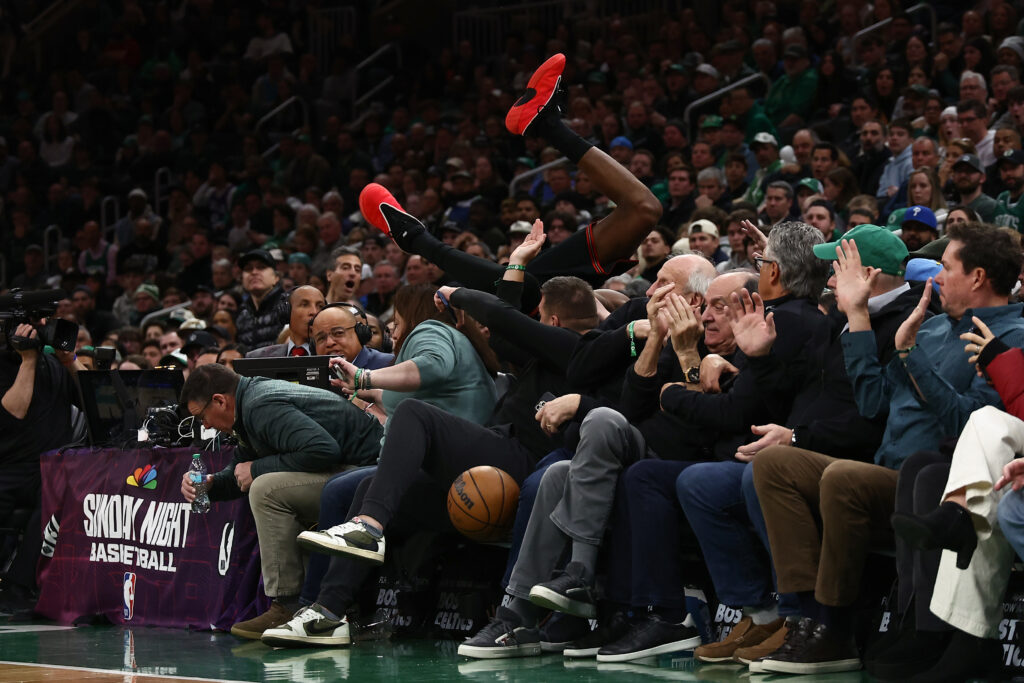 Vj Edgecombe #77 of the Philadelphia 76ers goes into the stands trying to save a ball from going out of bounds during the second half against the Boston Celtics at TD Garden on March 1, 2026 in Boston, Massachusetts.