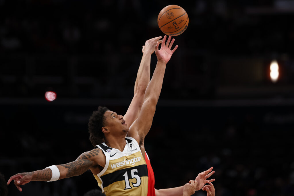 Julian Reese #15 of the Washington Wizards competes for the ball during the opening tipoff of his NBA debut against the Houston Rockets at Capital One Arena on March 2, 2026 in Washington, DC.