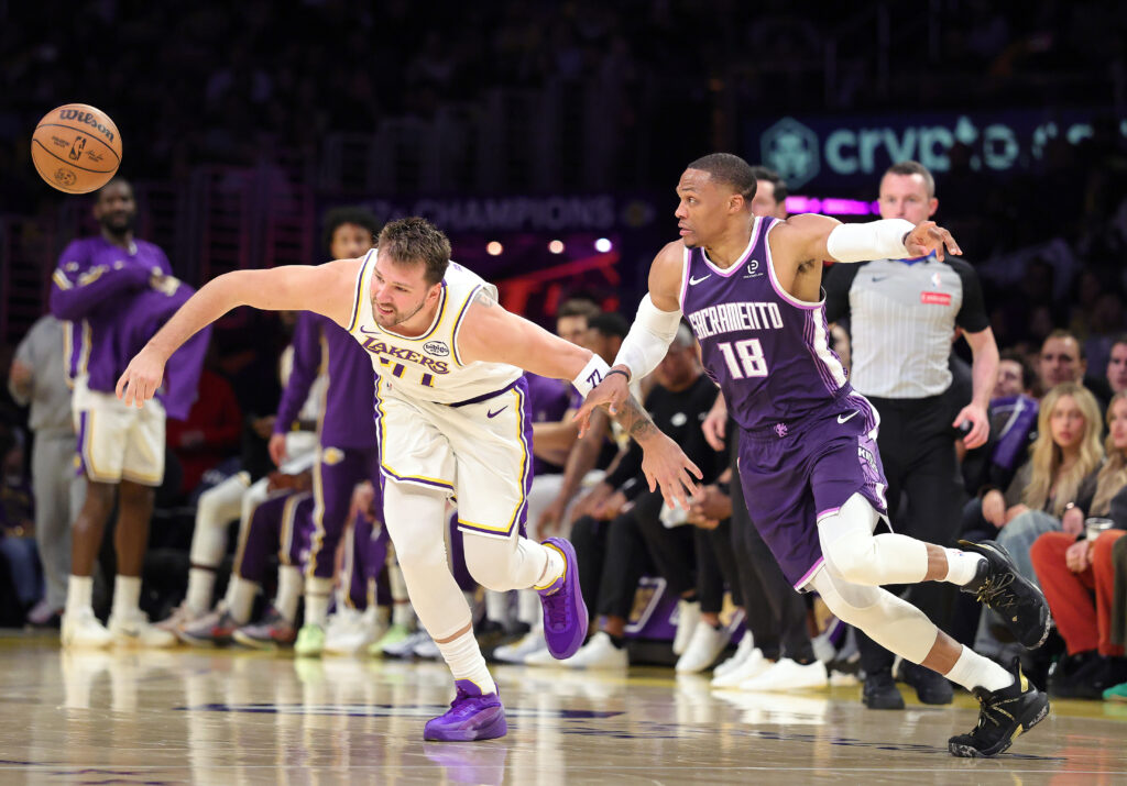 Luka Doncic #77 of the Los Angeles Lakers is fouled by Russell Westbrook #18 of the Sacramento Kings in the second half at Crypto.com Arena on March 01, 2026 in Los Angeles, California.