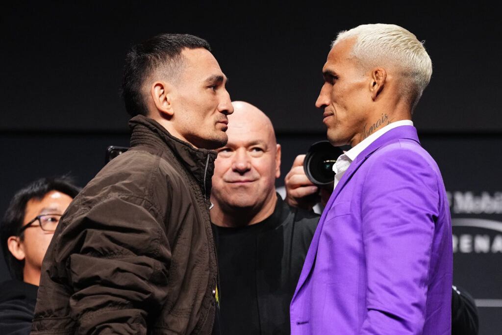 Opponents Max Holloway and Charles Oliveira of Brazil face off during the UFC 326 press conference at MGM Grand Garden Arena.