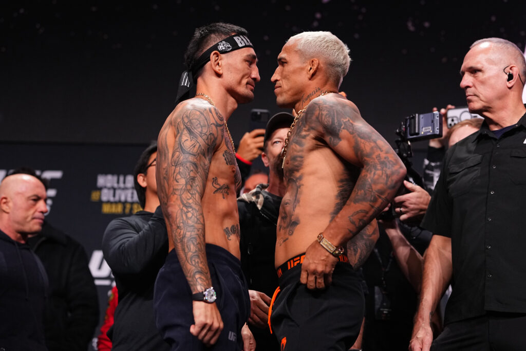 Opponents Max Holloway and Charles Oliveira of Brazil face off during the UFC 326 ceremonial weigh-in at MGM Grand Garden Arena.