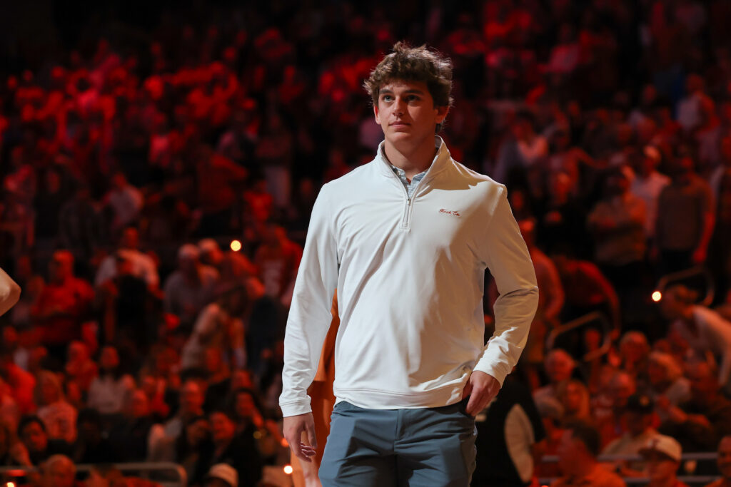 Quarterback Arch Manning of the Texas Longhorns is on the court during the SEC college basketball game between Texas Longhorns and Oklahoma Sooners.