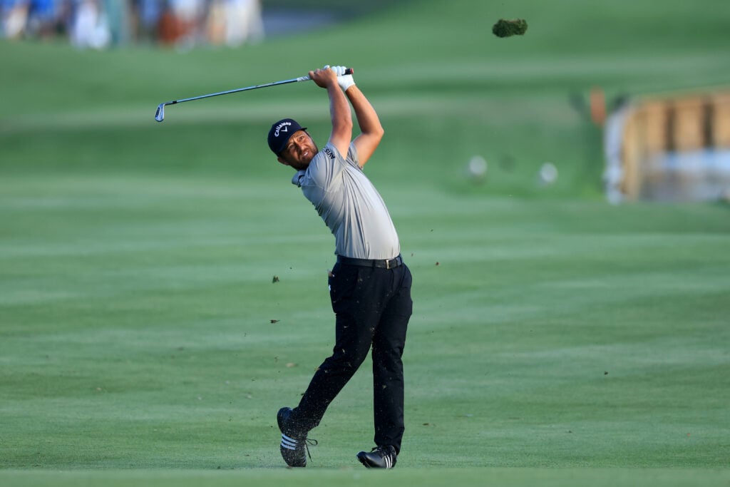 Xander Schauffele hits an approach into the 18th hole during the third round of The Players Championship