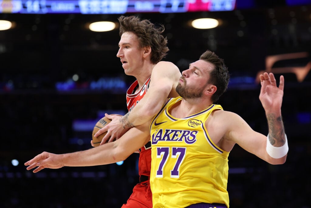 Matas Buzelis #14 of the Chicago Bulls intercepts a pass meant for Luka Doncic #77 of the Los Angeles Lakers during the first half of a game at Crypto.com Arena.