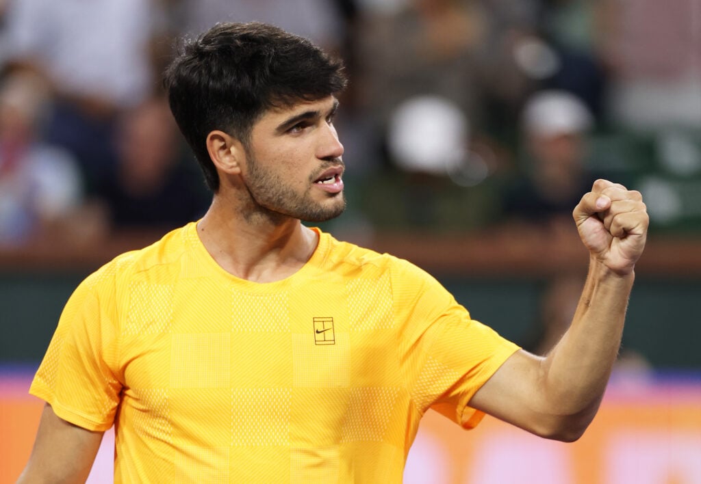 Carlos Alcaraz of Spain celebrates to his team box after his straight sets victory against Cameron Norrie of Great Britain in their quarterfinal match of the BNP Paribas Open at Indian Wells Tennis Garden.