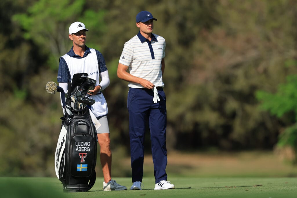 Ludvig Aberg speaks with his caddie during the final round of The Players Championship