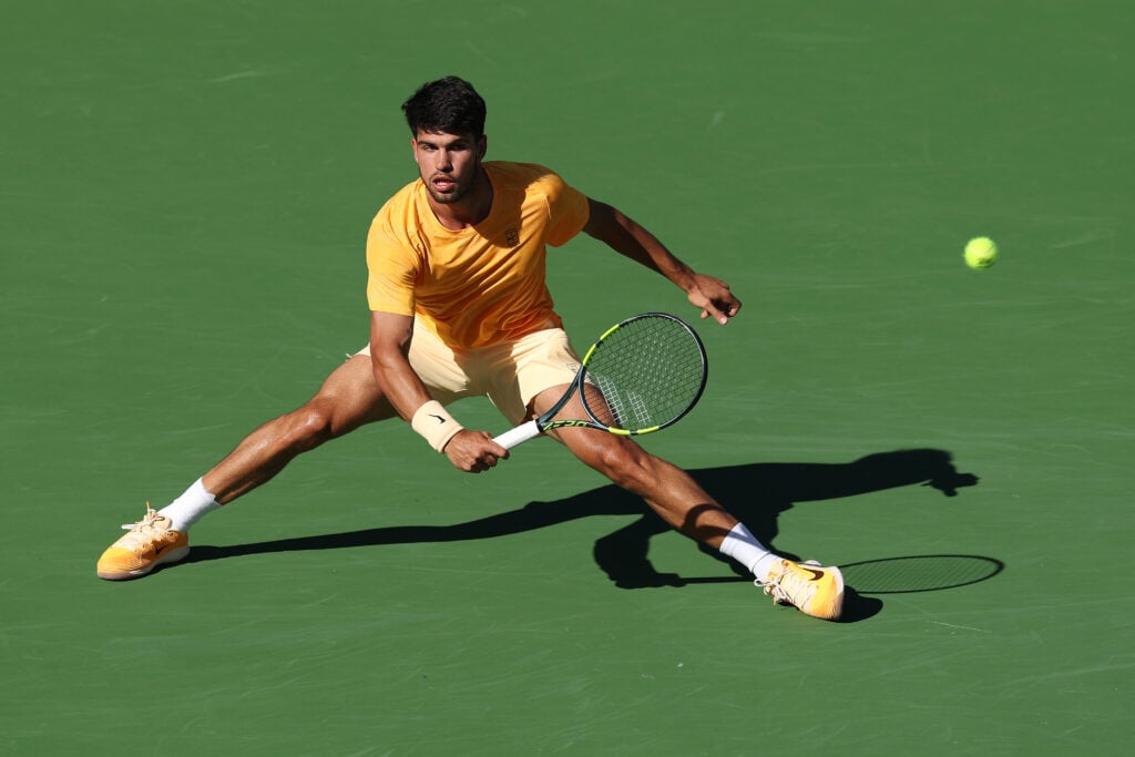 Carlos Alcaraz of Spain returns against Daniil Medvedev during their Men's Singles Semifinals match on Day 11 of the BNP Paribas Open at Indian Wells Tennis Garden.