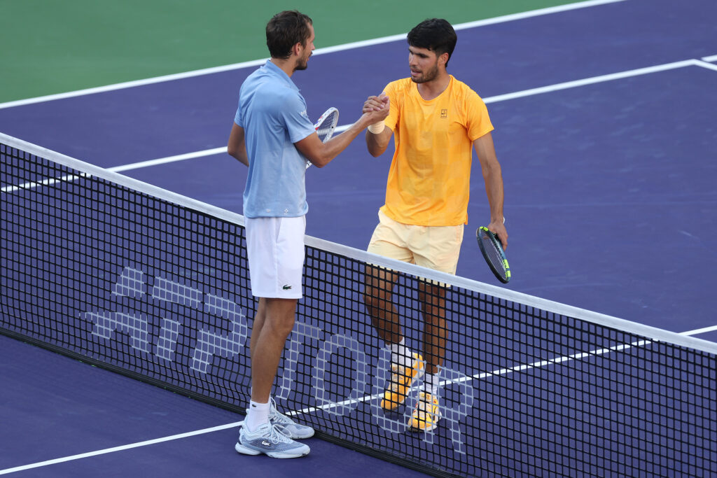 Carlos Alcaraz of Spain, right, shakes hands with Daniil Medvedev after being defeated during their Men's Singles Semifinals match on Day 11 of the BNP Paribas Open at Indian Wells Tennis Garden.