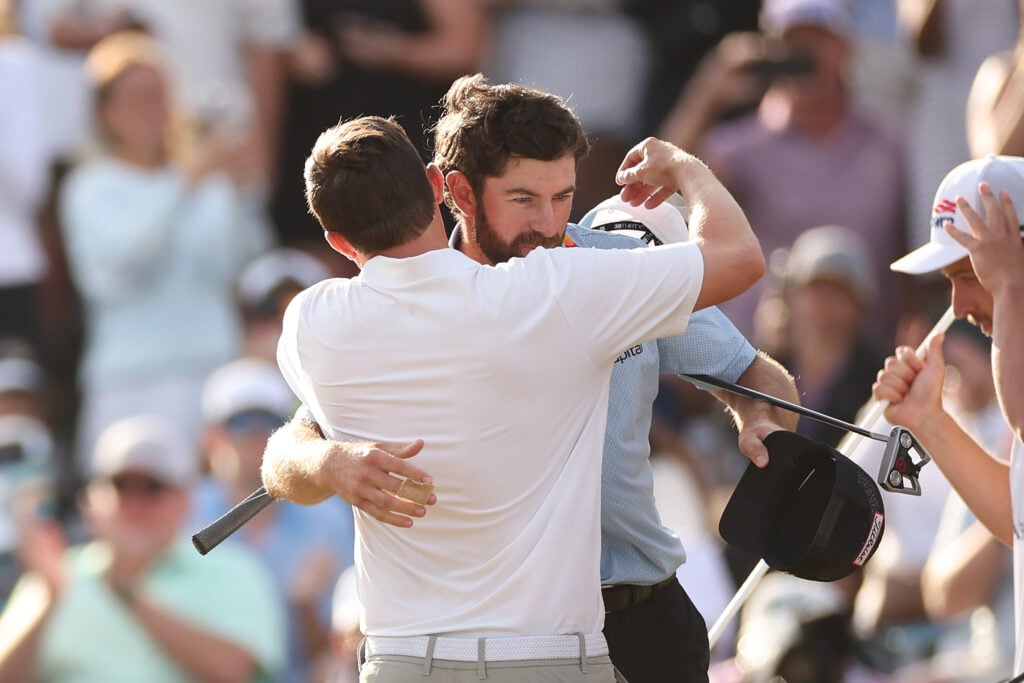 Cam Young and Matt Fitzpatrick embrace after THE PLAYERS Championship