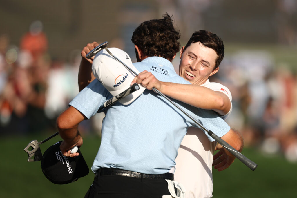 Cam Young and Matt Fitzpatrick embrace on the 18th green after the final round of The Players Championship