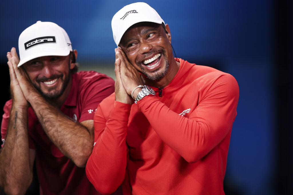 Tiger Woods and Max Homa of Jupiter Links GC react after defeating Boston Common Golf