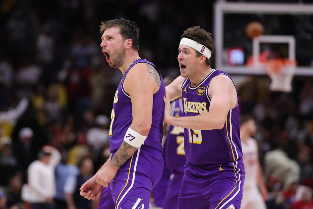 Austin Reaves #15 of the Los Angeles Lakers celebrates with Luka Doncic #77 of the Los Angeles Lakers during the second half against the Houston Rockets at Toyota Center.