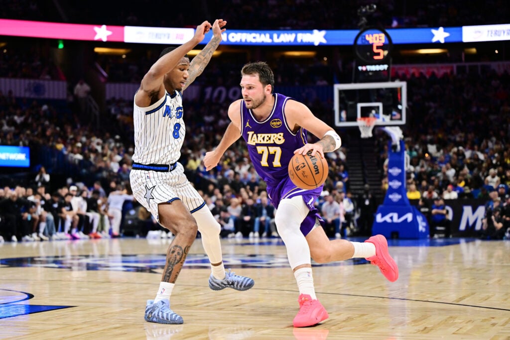 Luka Doncic #77 of the Los Angeles Lakers goes to the basket against Jamal Cain #8 of the Orlando Magic in the first half of the game at Kia Center.