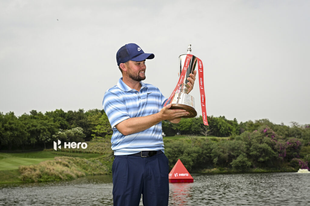 Alex Fitzpatrick of England poses with the trophy following victory on day four of the Hero Indian Open 2026 at DLF Golf and County Club