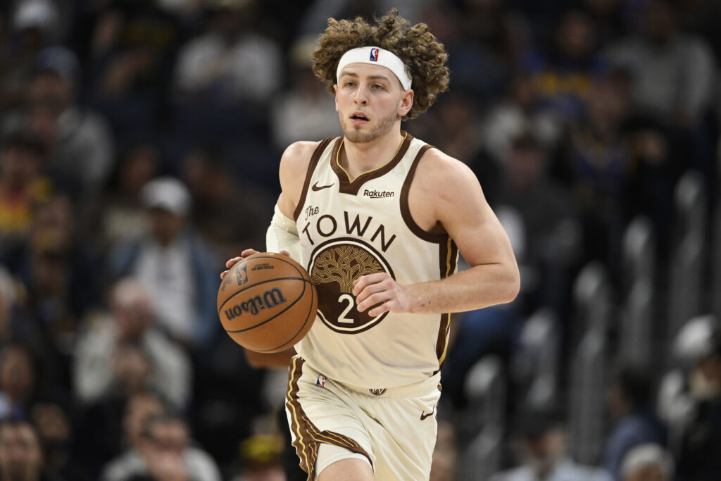 Brandin Podziemski #2 of the Golden State Warriors dribbles against the Washington Wizards in the third quarter at Chase Center.