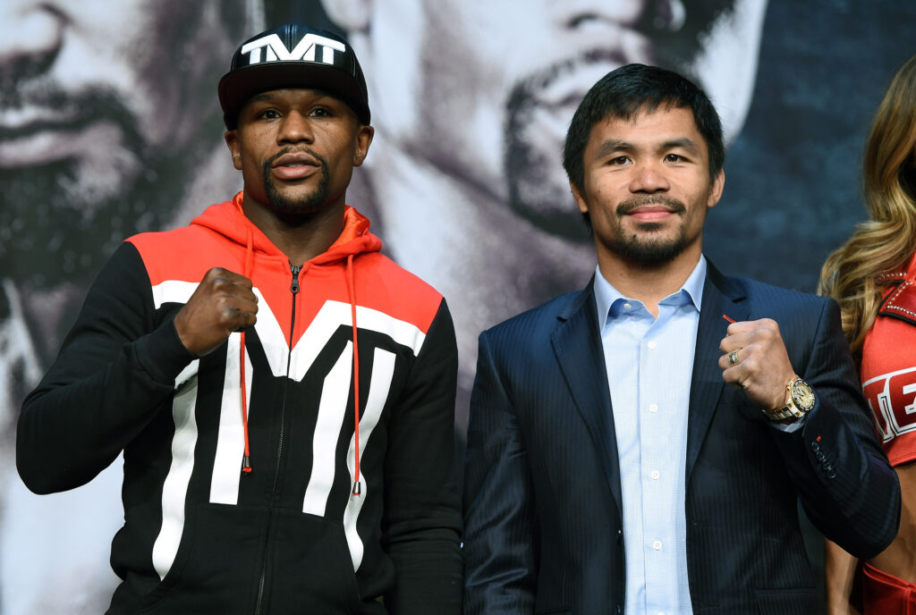WBC/WBA welterweight champion Floyd Mayweather Jr. (L) and WBO welterweight champion Manny Pacquiao pose during a news conference at the KA Theatre at MGM Grand Hotel & Casino.