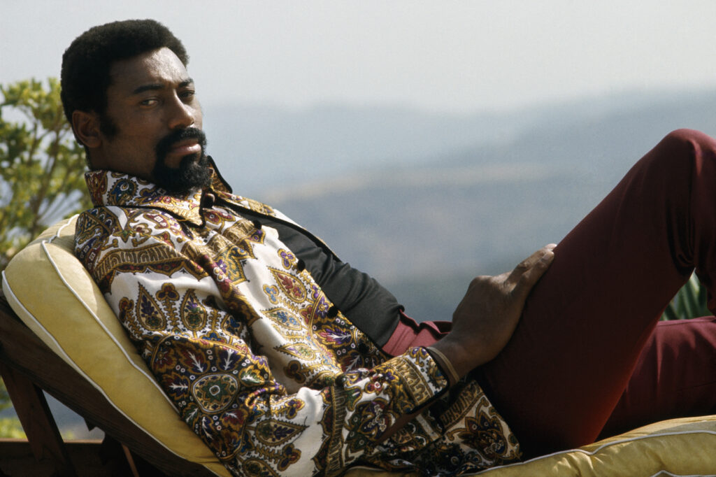 Los Angeles Lakers center Wilt Chamberlain #13 lounges on his deck chair in his backyard.