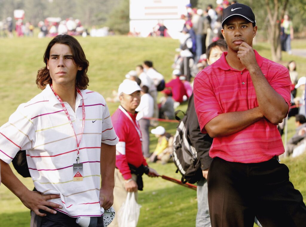 Tiger Woods of USA (right) stands with Rafael Nadal, Spanish tennis star, on the 14th hole during the final round of The HSBC Champions tournament at The Sheshan International Golf Club on November 12, 2006 in Shanghai, China.