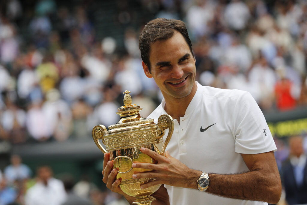 Switzerland's Roger Federer holds the winner's trophy after beating Croatia's Marin Cilic in their men's singles final match, during the presentation on the last day of the 2017 Wimbledon Championships at The All England Lawn Tennis Club in Wimbledon, southwest London, on July 16, 2017. Roger Federer won 6-3, 6-1, 6-4.