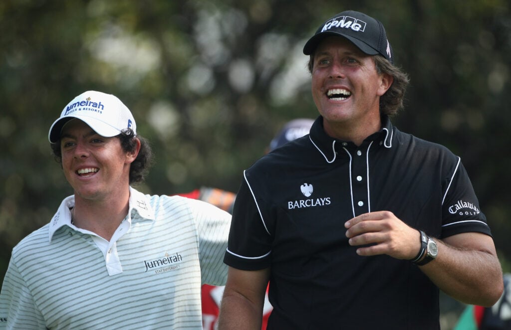 Phil Mickelson of the USA (right) and Rory McIlroy of Northern Ireland share a joke on the fifth hole during the second round of the WGC-HSBC Champions