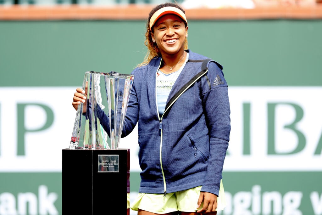 Naomi Osaka of Japan poses with the winner's trophy after defeating Daria Kasatkina of Russia during the women's final on Day 14 of the BNP Paribas Open at the Indian Wells Tennis Garden on March 18, 2018 in Indian Wells, California.