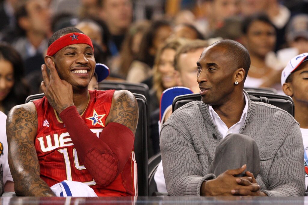Carmelo Anthony #15 and Kobe Bryant #24 of the Western Conference share a laugh during the NBA All-Star Game, part of 2010 NBA All-Star Weekend at Cowboys Stadium.