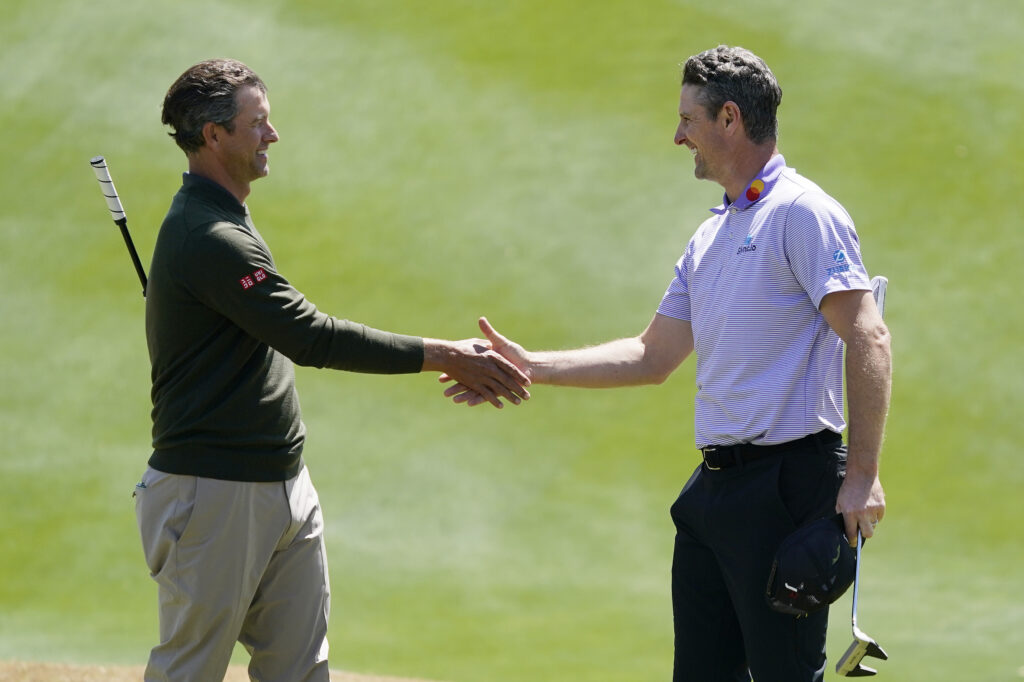 Adam Scott of Australia shakes hands with Justin Rose of England after their match during the first day of the World Golf Championships