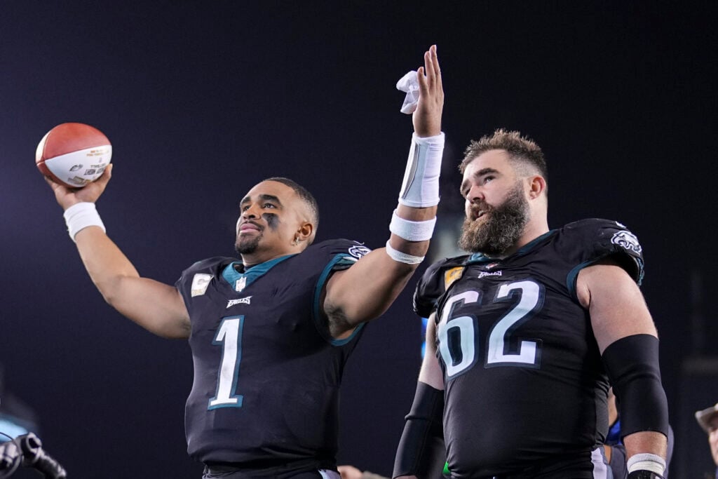 Jalen Hurts #1 and Jason Kelce #62 of the Philadelphia Eagles walk off the field after the game against the Green Bay Packers at Lincoln Financial Field.
