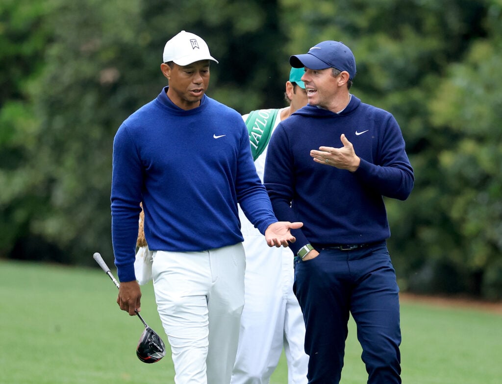 Rory McIlroy and Tiger Woods walk together on the 11th hole during a practice round prior to the 2023 Masters at Augusta National