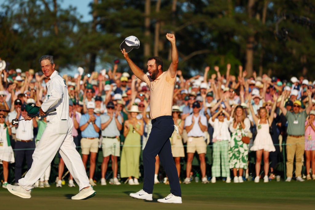 Scottie Scheffler of the United States and caddie Ted Scott celebrate on the 18th green after winning the 2024 Masters Tournament at Augusta National