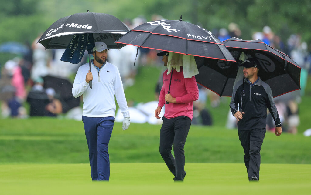 Scottie Scheffler walks off the 10th tee with Wyndham Clark and Brian Harman during the second round of the 2024 PGA Championship