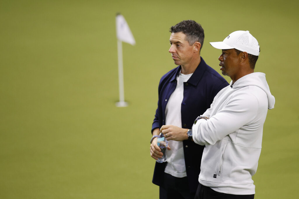 Rory McIlroy of Boston Common Golf and Tiger Woods of Jupiter Links Golf Club look on before the TGL presented by SoFi match between the New York Golf Club and The Bay Golf Club at SoFi Center