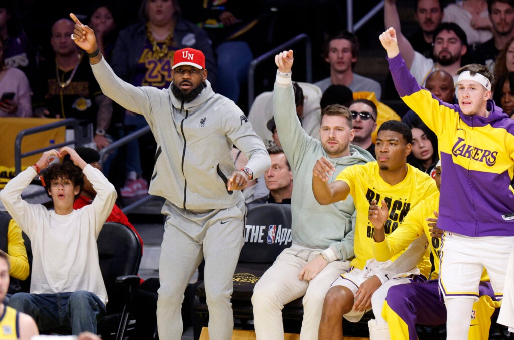 LeBron James, Luka Doncic , Rui Hachimura and Austin Reaves of the Los Angeles Lakers celebrate during the first half against the Indiana Pacers at Crypto.com.