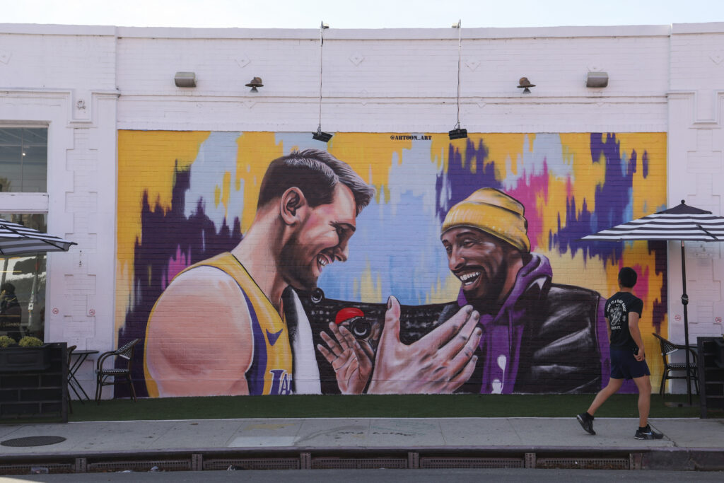 A new mural depicting Kobe Bryant greeting Luka Doncic at Carrera Cafe.