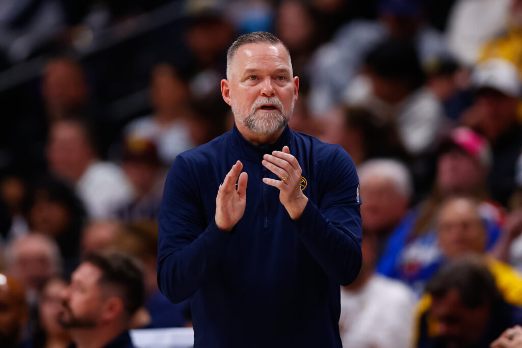Head Coach Michael Malone claps on the sidelines during the third quarter against the Indiana Pacers at Ball Arena.