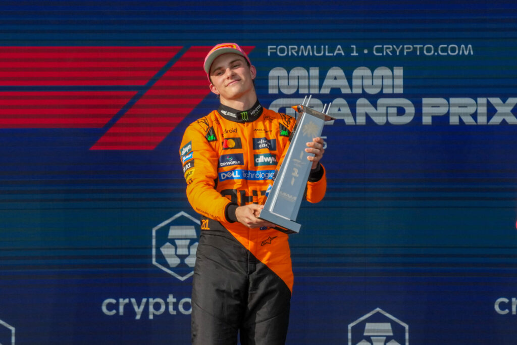 Oscar Piastri, Lando Norris, and George Russell stand on the podium during the Formula 1 Crypto.Com Miami Grand Prix 2025 in Miami, USA, on May 4, 2025.