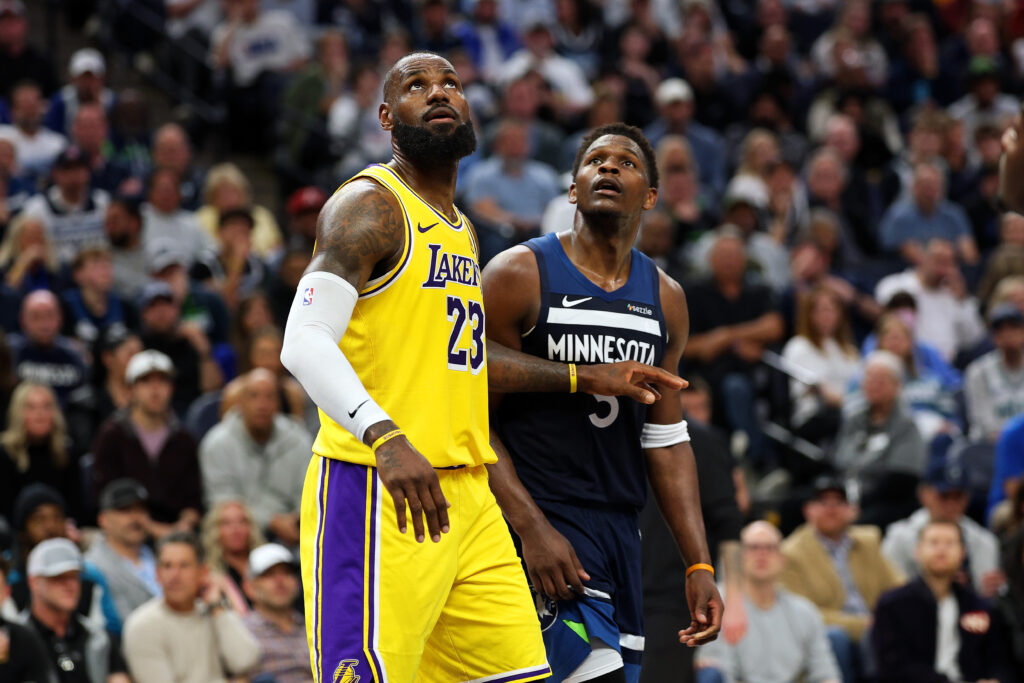 LeBron James #23 of the Los Angeles Lakers competes against Anthony Edwards #5 of the Minnesota Timberwolves in the third quarter of Game Three of the First Round of the 2025 NBA Playoffs at Target Center.