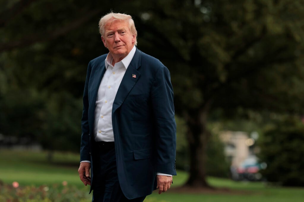U.S. President Donald Trump walks across the South Lawn of the White House after returning on Marine One.