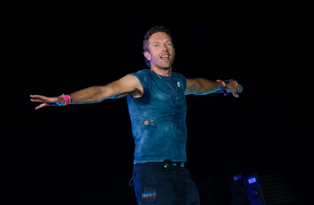 Chris Martin of Coldplay performs onstage during a concert at Wembley Stadium.