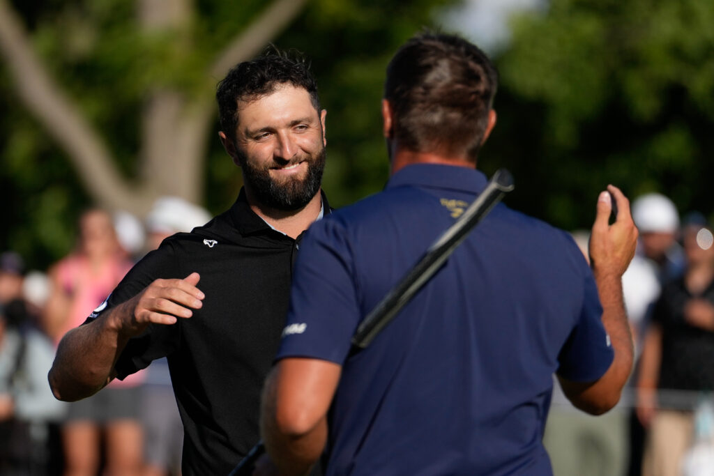 John Rahm shakes hands with Bryson DeChambeau at the LIV Golf Team Championship Michigan