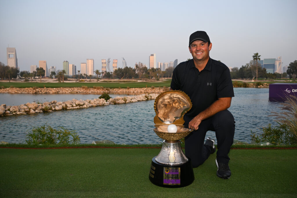 Patrick Reed celebrates with the trophy after winning the Qatar Masters