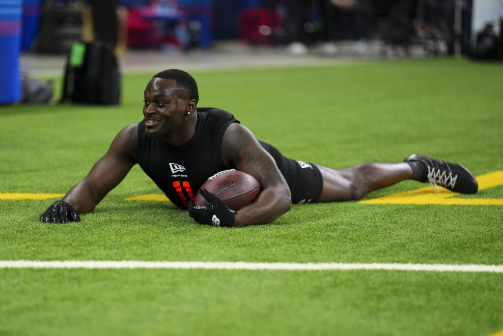 Jeremiyah Love #RB11 of Notre Dame participates in a drill during the 2026 NFL Scouting Combine at Lucas Oil Stadium.