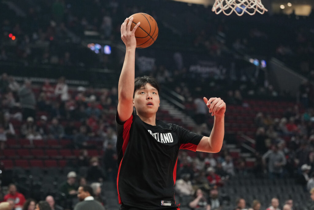 Yang Hansen #16 of the Portland Trail Blazers warms up before the game against the Utah Jazz at Moda Center.