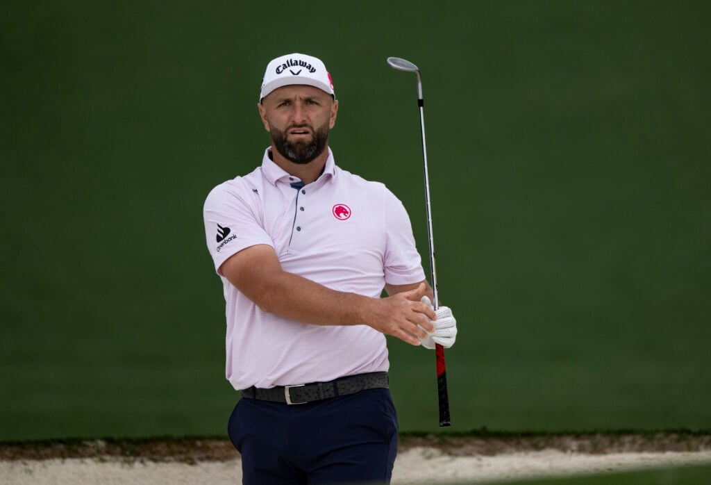Masters champion Jon Rahm of Spain plays a stroke from a bunker on the No. 2 hole during a practice round prior to the Masters at Augusta National Golf Club