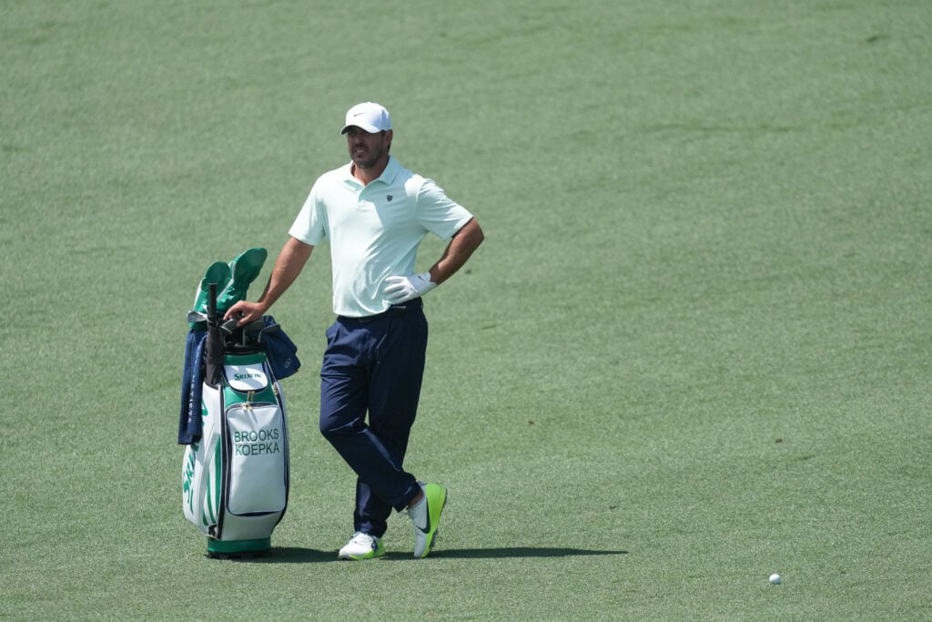 Brooks Koepka waits on the ninth fairway during a practice round ahead of The Masters