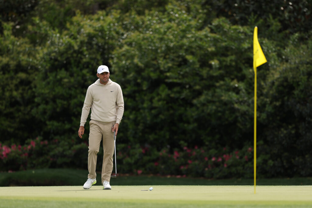 Scottie Scheffler practices his putting on the 11th green in a round ahead of The Masters